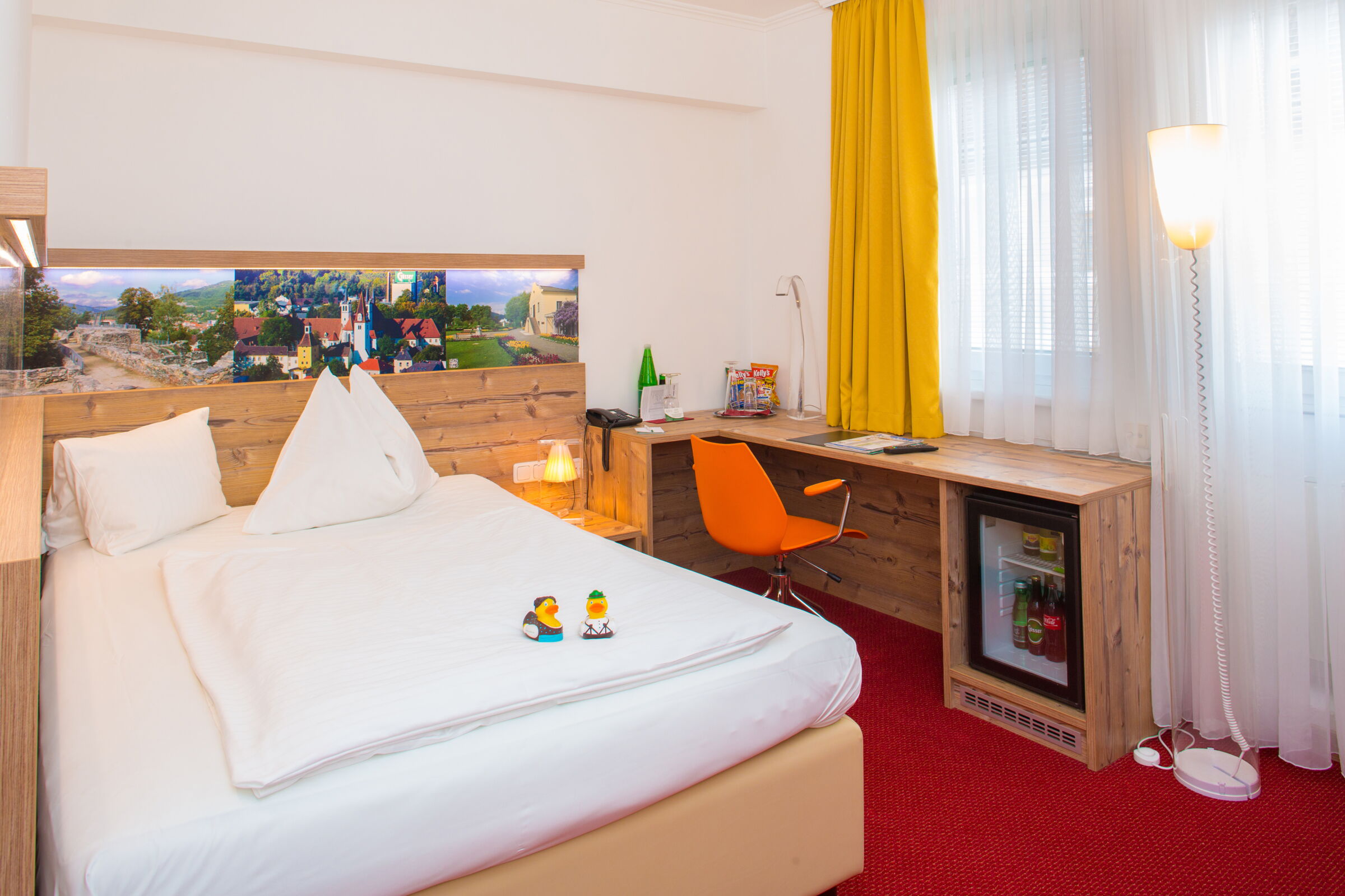 Bed in a red carpeted room