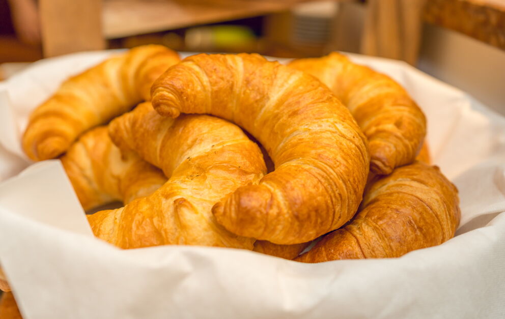 A breakfast basket filled to the brim with delicious fresh croissants