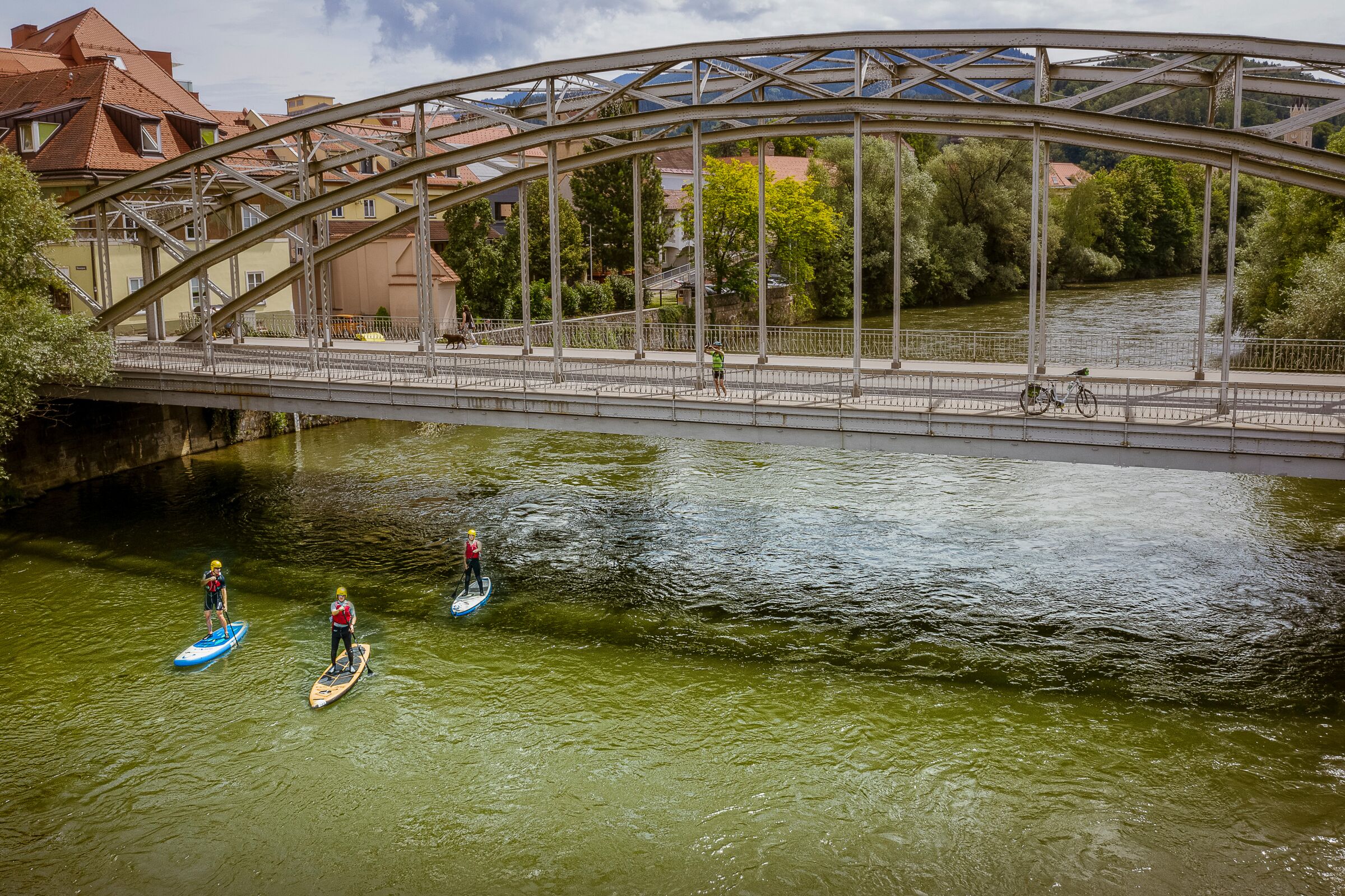 Three stand-up paddlers on the river Mur under a bridge; © Pixelmaker.at