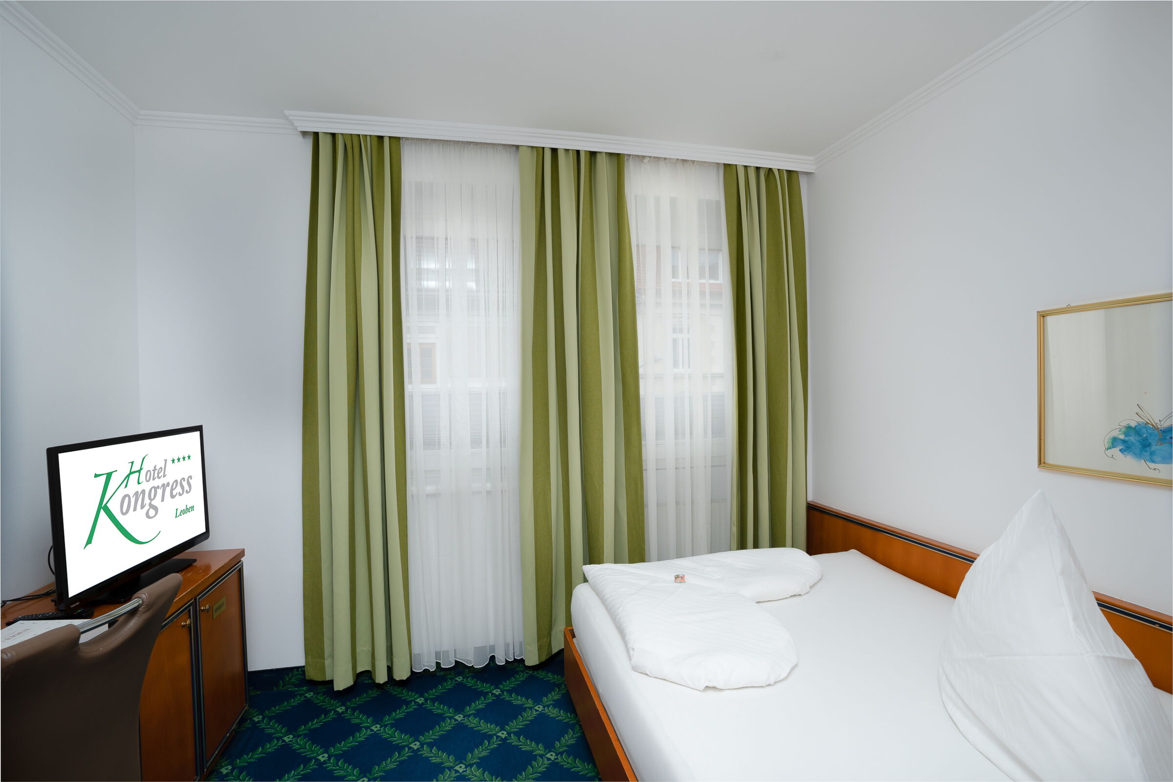 green curtain in front of the window in the single bed room