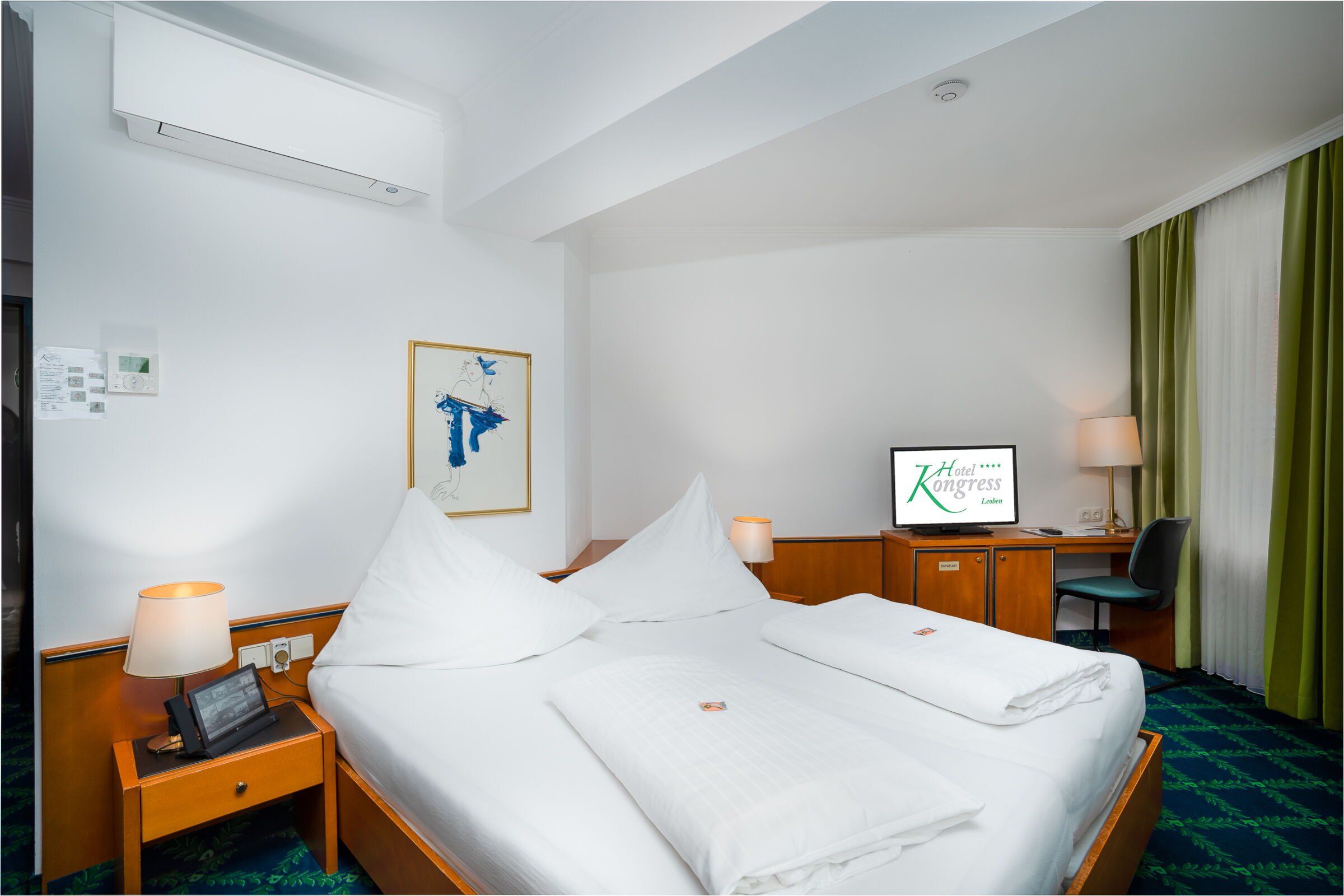 small double bed room with green curtain and blue carpet and picture on the wall